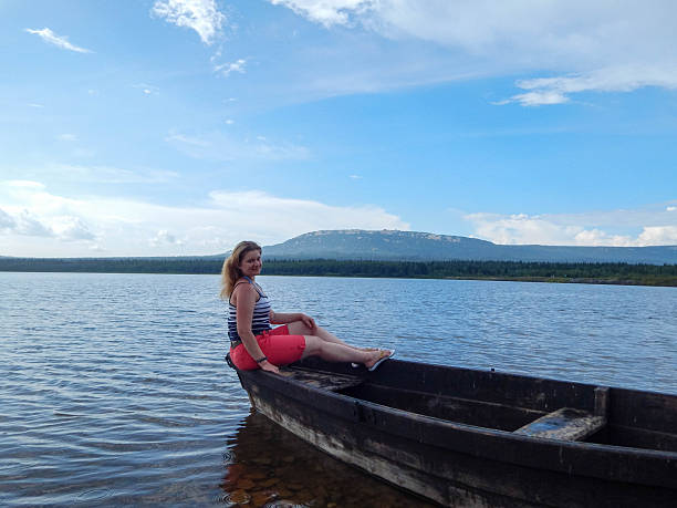 Group of paddlers preparing boats near a lake